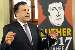 Stephan Dorgerloh, Kultusminister von Sachsen-Anhalt vor Logo der Lutherdekade